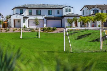 a soccer field in front of a house